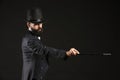 Male magician showing tricks on dark background Royalty Free Stock Photo