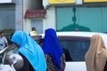 Three maldivian women with colored veil muslim religion