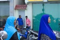 Two maldivian women with a blue veil muslim religion