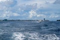 Speedboats on the choppy waters of the Indian Ocean transport passengers, divers, and hotel