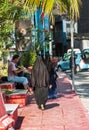 MALE, MALDIVES - NOVEMBER, 27, 2016: Woman in a black burqa on a city street. Copy space for text. Vertical.