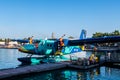 Male, Maldives, 20.11.2020. Trans Maldivian Airways colorful seaplane Twin Otter Series 400 docked at seaplane terminal Royalty Free Stock Photo