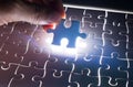 Male or Man Hand and Finger put Piece of Jigsaw in Place to Solve or Match Puzzle Royalty Free Stock Photo