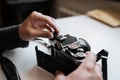 Male man hands reloading film in pentax retro camera on a white table Royalty Free Stock Photo