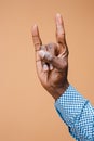 Male, man, hipster, in shirt, hand raised showing a heavy metal rock sign Royalty Free Stock Photo