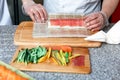 Male man preparing homemade sushi rolls. Forming sushi. The steps for creating sushi with salmon. Process of sushi Royalty Free Stock Photo