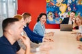 The male manager holds a meeting for subordinates in the meeting room.