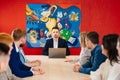 The male manager holds a meeting for subordinates in the meeting room.