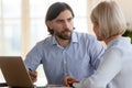 Male manager insurer consulting middle aged client explaining benefits Royalty Free Stock Photo