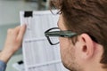 Close-up of a financial businessman holding an information sheet in his hands, reading the company& x27;s financial Royalty Free Stock Photo