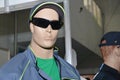 A male mannequin wearing water resistant overalls, coveralls, uniform, safety workware, T-shirt, protective glasses and ball cap,