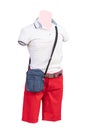 Male mannequins. Closeup of male mannequin dressed in white cotton shirt and red short pants and a blue bag, isolated on a white Royalty Free Stock Photo