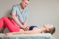 Male manual visceral therapist masseur treats a young female patient. Edit the internal organs and the elimination of