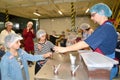 Male master hands out chocolate mass to children for tasting. Children `s tour to the Belgostar chocolate factory