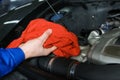 Male mechanic checking engine oil level in car service center Royalty Free Stock Photo