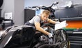 Male mechanic diagnoses modern motorcycle in service center