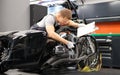 Male mechanic diagnoses parts on motorcycle at service center