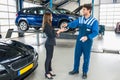 Male Mechanic Giving Car Key To Client After Servicing