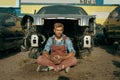 Male mechanic poses on car junkyard Royalty Free Stock Photo