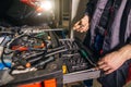 Mechanic taking facilities from special box for mechanical instruments Royalty Free Stock Photo