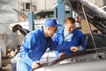 Male mechanics fixing car in service center Royalty Free Stock Photo