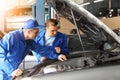 Male mechanics fixing car in service center Royalty Free Stock Photo