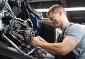 Male mechanik repair motorcycle in special service portrait.