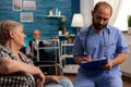 Male nurse filling out medical history of senior patient Royalty Free Stock Photo