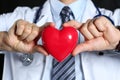 Male medicine doctor wearing hold in hands red toy heart Royalty Free Stock Photo