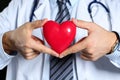 Male medicine doctor wearing hold in hands red toy heart Royalty Free Stock Photo