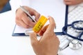 Male medicine doctor write prescription at worktable