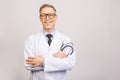 Male medicine therapeutist doctor hands crossed on his chest holding stethoscope closeup isolated on grey background. Medical help Royalty Free Stock Photo