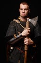 Male medieval warrior in armour and chain mail, viking with batt