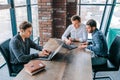 A male mentor leading a group of trainees through a presentation on their laptops Royalty Free Stock Photo