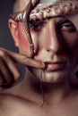 Male model close up portrait with make up and octopus, sea life concept Royalty Free Stock Photo