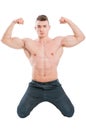 Male model on his knees flexing strong arms Royalty Free Stock Photo