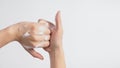 Male model is interlock fingers and rub mid-joints with foaming hand soap on white background