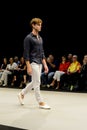 Male model odel wearing a black shirt and black trousers on the catwalk during the Adlib fashion collection at Momad 2023