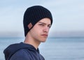 Male model wearing black knitted beanie with Bluetooth speakers inside