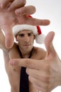 Male model wearing christmas hat and framing Royalty Free Stock Photo