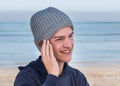 Male model wearing gray knitted beanie with Bluetooth speakers inside