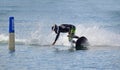 Male Motosurf Competitor Taking very tight line around marker.