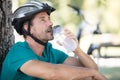male mountain biker drinking water in forest Royalty Free Stock Photo