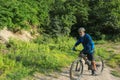 A male mountain biker on a forest trail