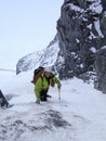 Male mountain climber heading up a steep snow gully and couloir early in the morning on his way to a high alpine peak in Switzerla Royalty Free Stock Photo