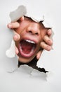 Male mouth screaming from cracked wall Royalty Free Stock Photo