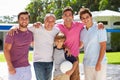 Male Multi Generation Family Playing Volleyball In Garden