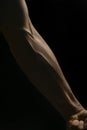 Male muscular male arm with inflated veins close-up on a black background Royalty Free Stock Photo