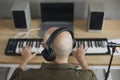 Male musician in earphones compose music on keyboards Royalty Free Stock Photo