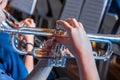 Male musician hands holding and playing trumpet in a band concert Royalty Free Stock Photo